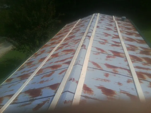 Rusted metal roof panels with new wood purlins before replacement — Storm Damage Roof Repair in Trussville by Roofing Brothers