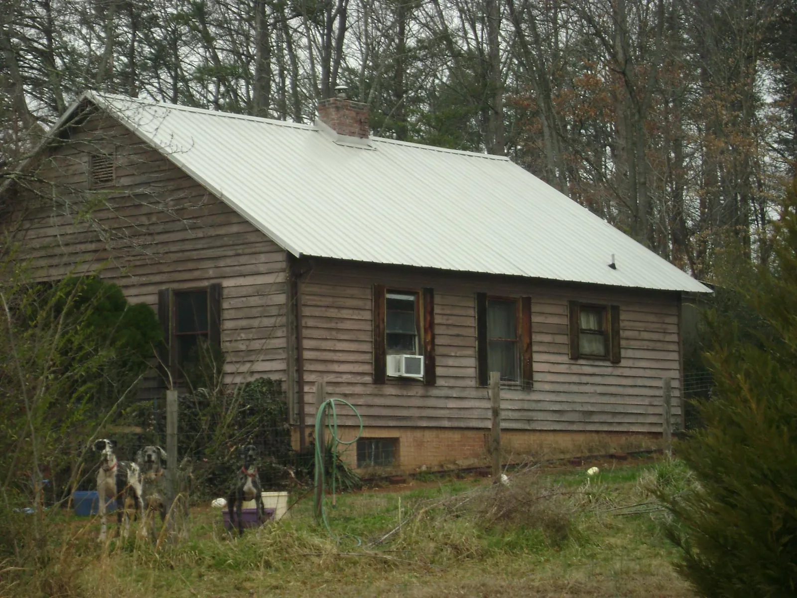 White metal roof on an old wood sided farmhouse, from a Metal Roof Installation job in Trussville